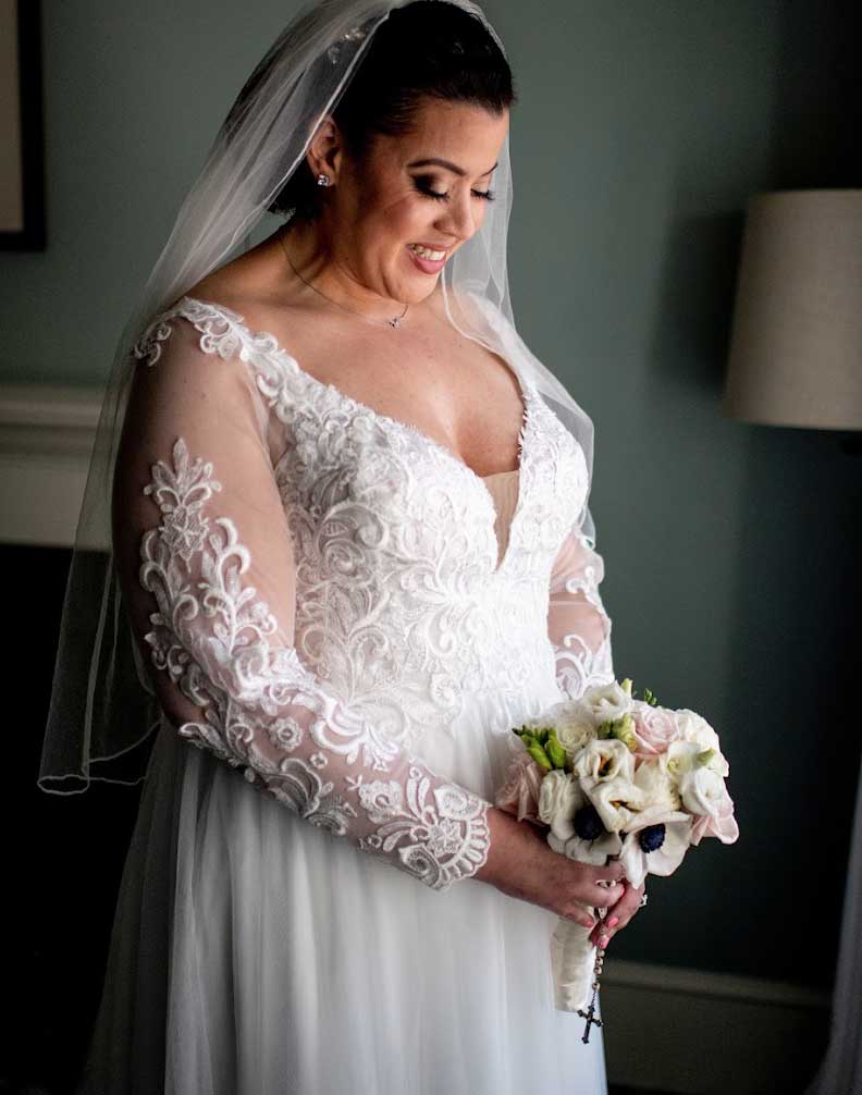 A bride in a wedding dress holding her bouquet