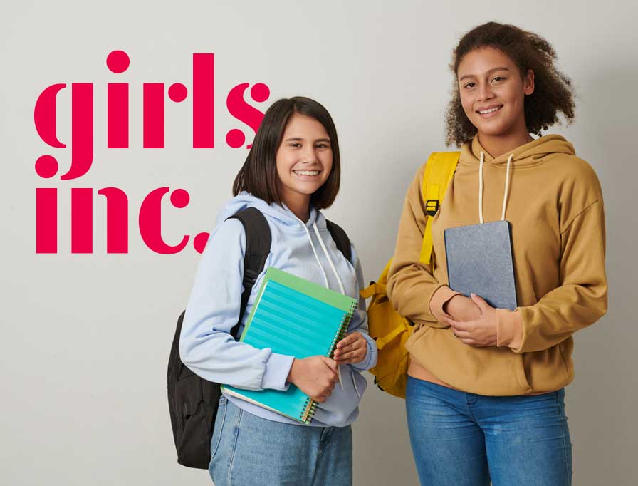 Two girls standing next to each other with the words girls inc.