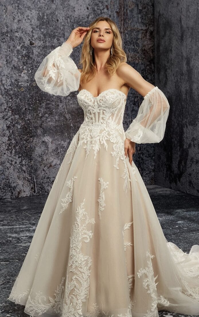 The bride is wearing a long sleeved wedding dress with sheer sleeves.