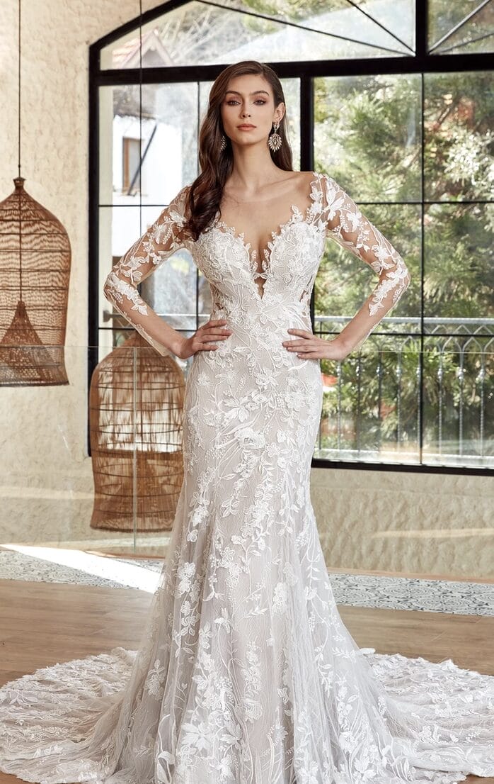 A mermaid wedding dress with long sleeves and lace appliques.