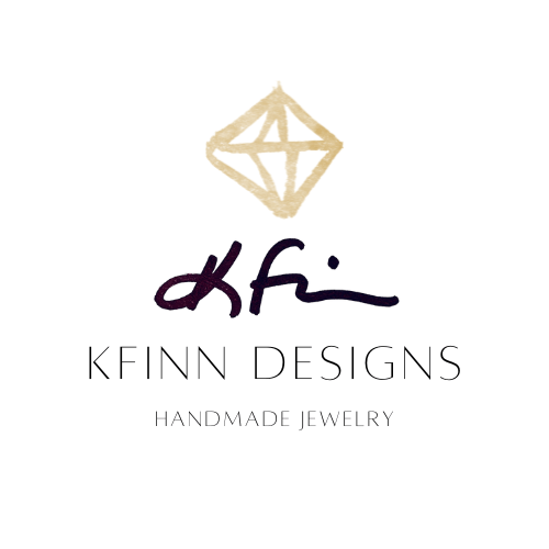 Logo for KFinn Designs featuring a stylized gold diamond shape above the text "KFinn Designs" and "Handmade Jewelry.